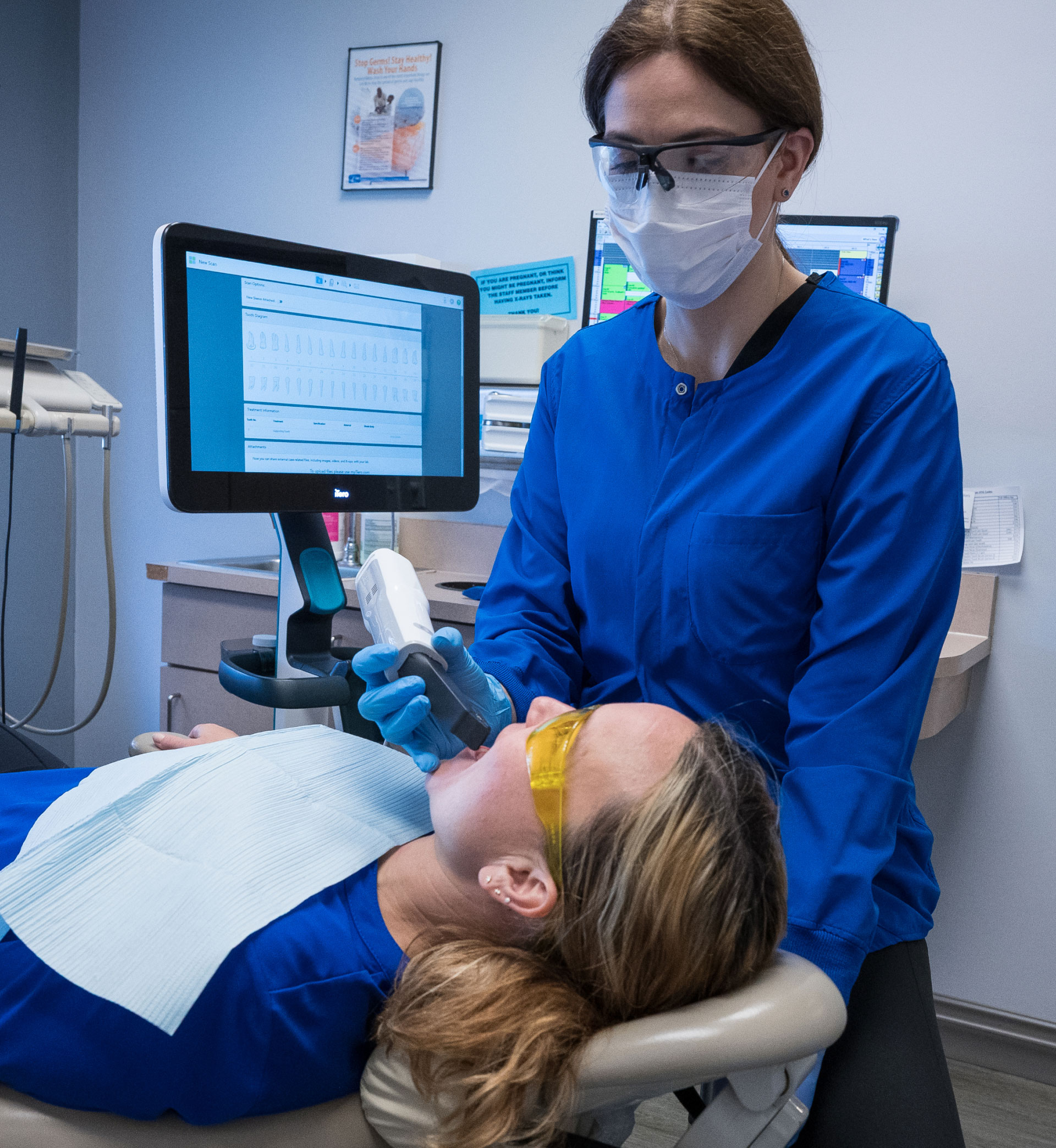 assistant using the itero scanner on patient in dental chair